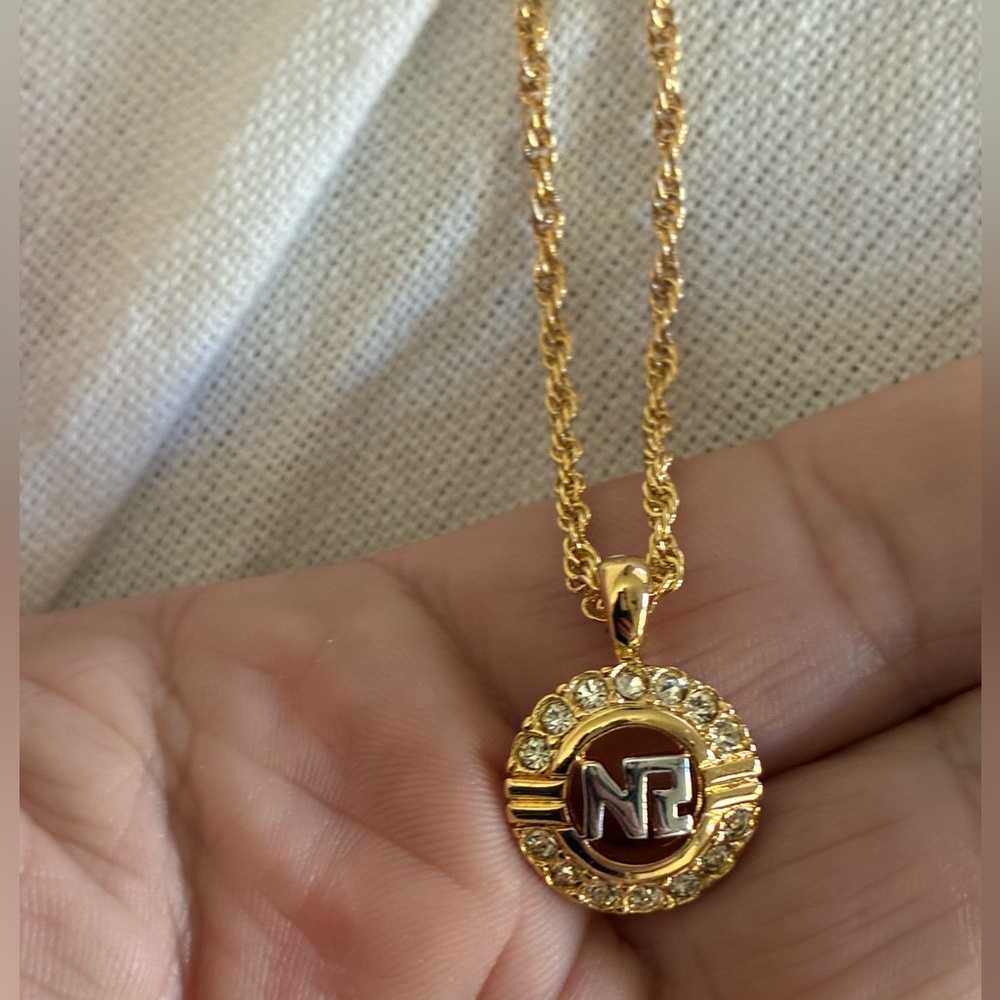 Nina Ricci Gold-tone Logo Pendant Necklace with Clear Stones